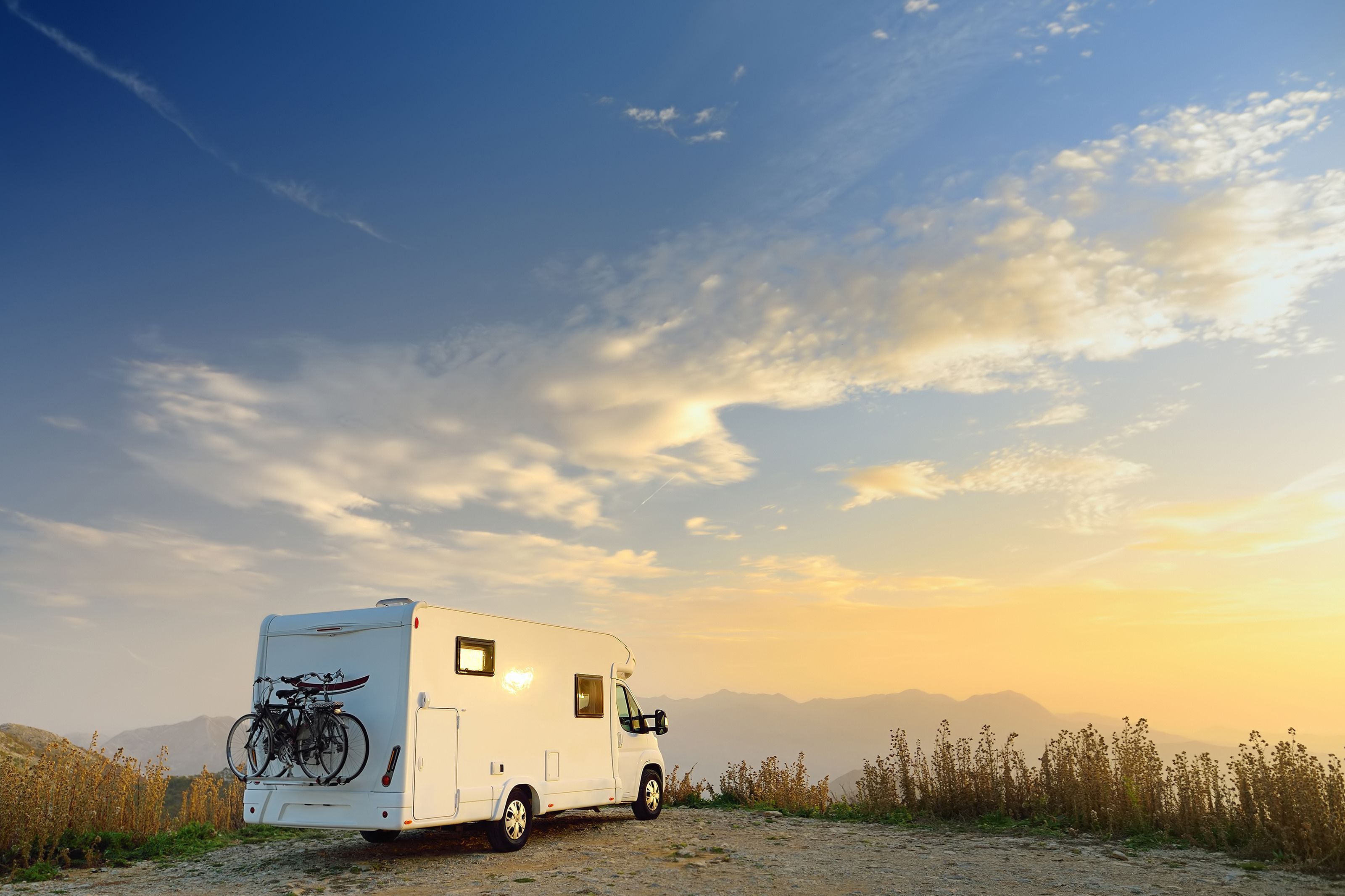an RV membership programs RV parked on a cliff overlooking a beautiful landscape
